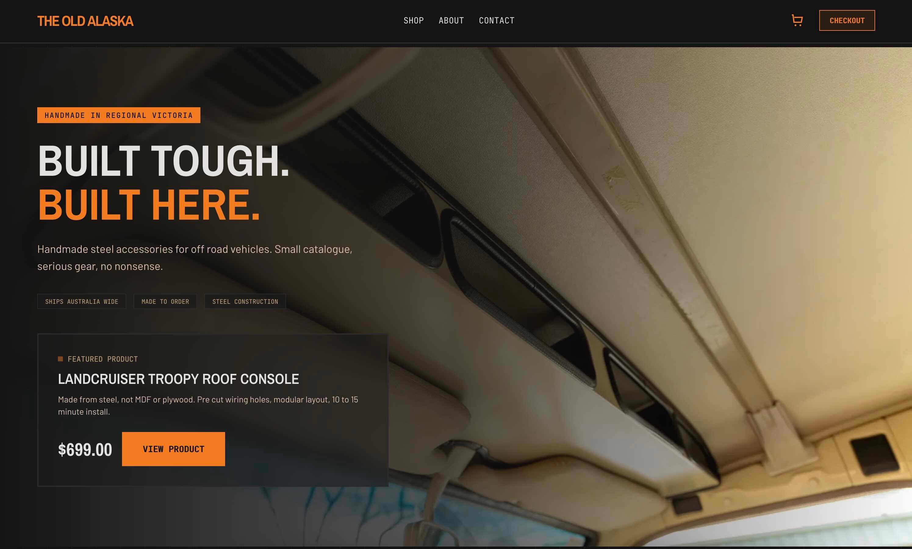Screenshot of The Old Alaska homepage with a dark hero, orange brand mark, and featured Troopy roof console