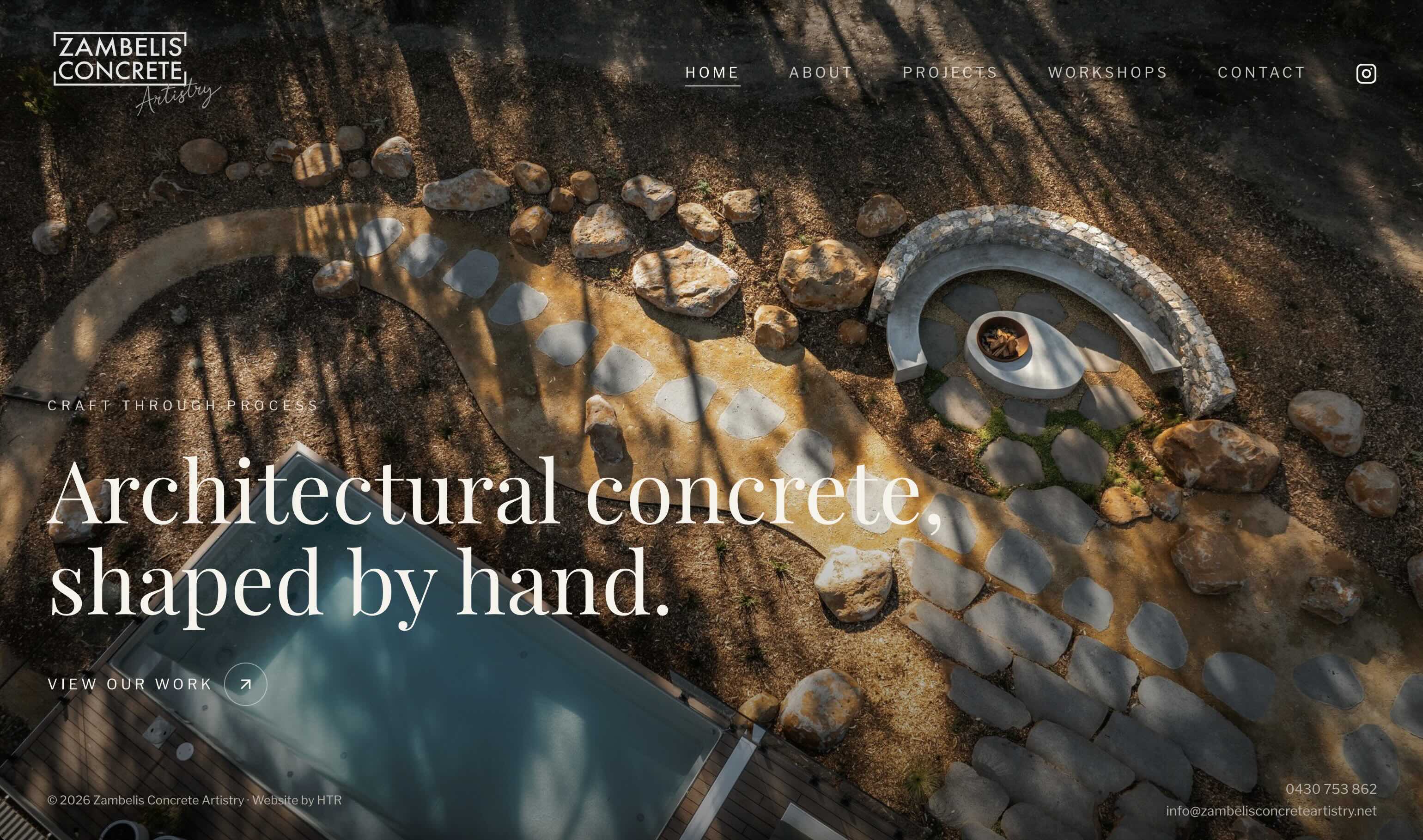 Zambelis Concrete Artistry homepage showing an aerial view of a curved concrete seat and firepit